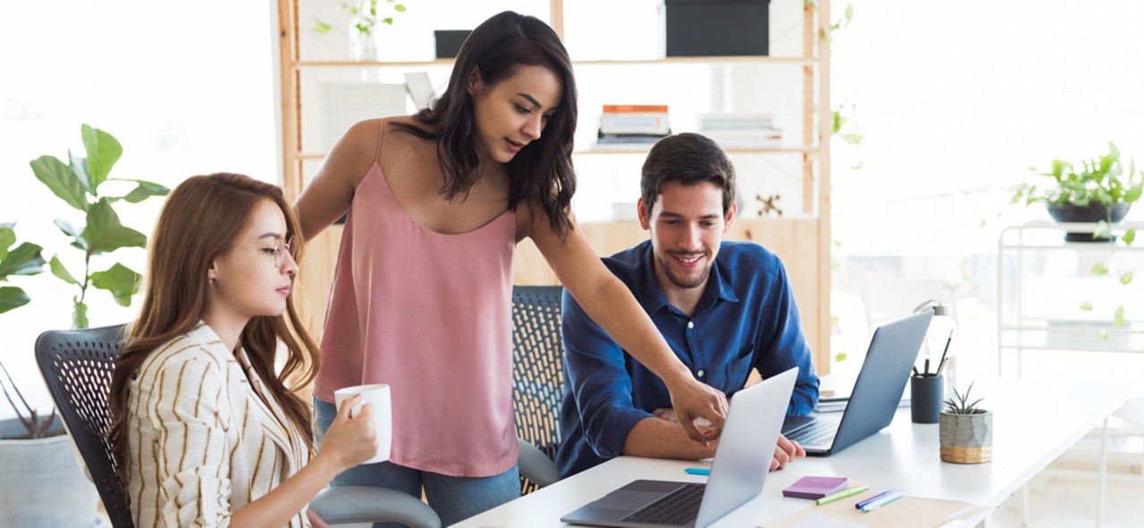 Latin millennial business team working in the office.