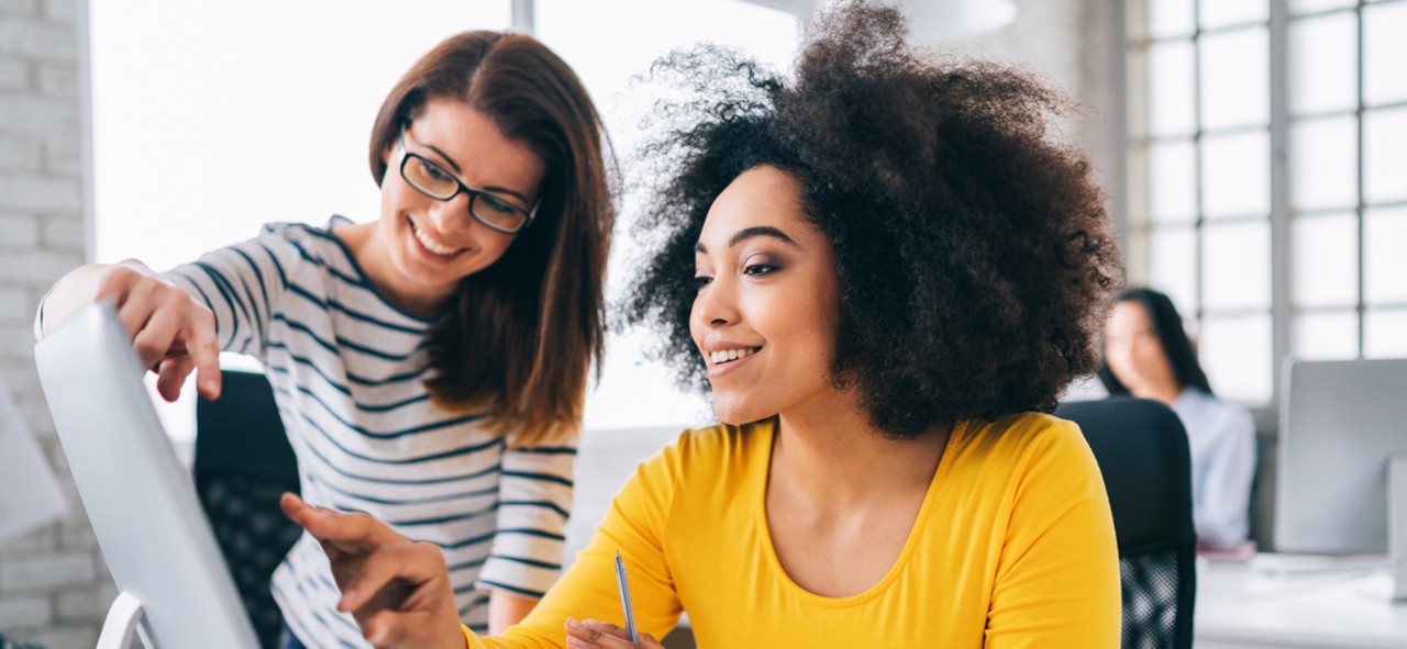Afro Female manager discussing business in creative office