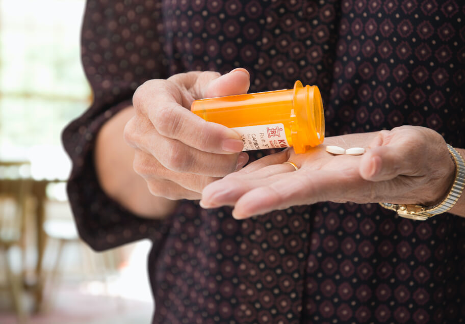A person holding prescription pills