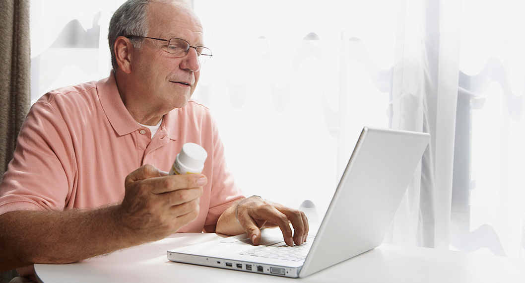 An older man comparing Medicare Part D plans for cost effectiveness for his medication